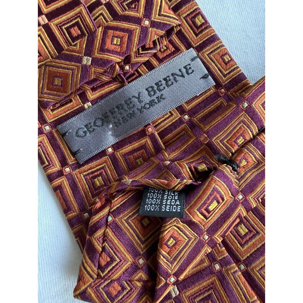 Geoffrey Beene	Burgundy Orange Psychedelic Geometric Woven Jacquard Silk Tie